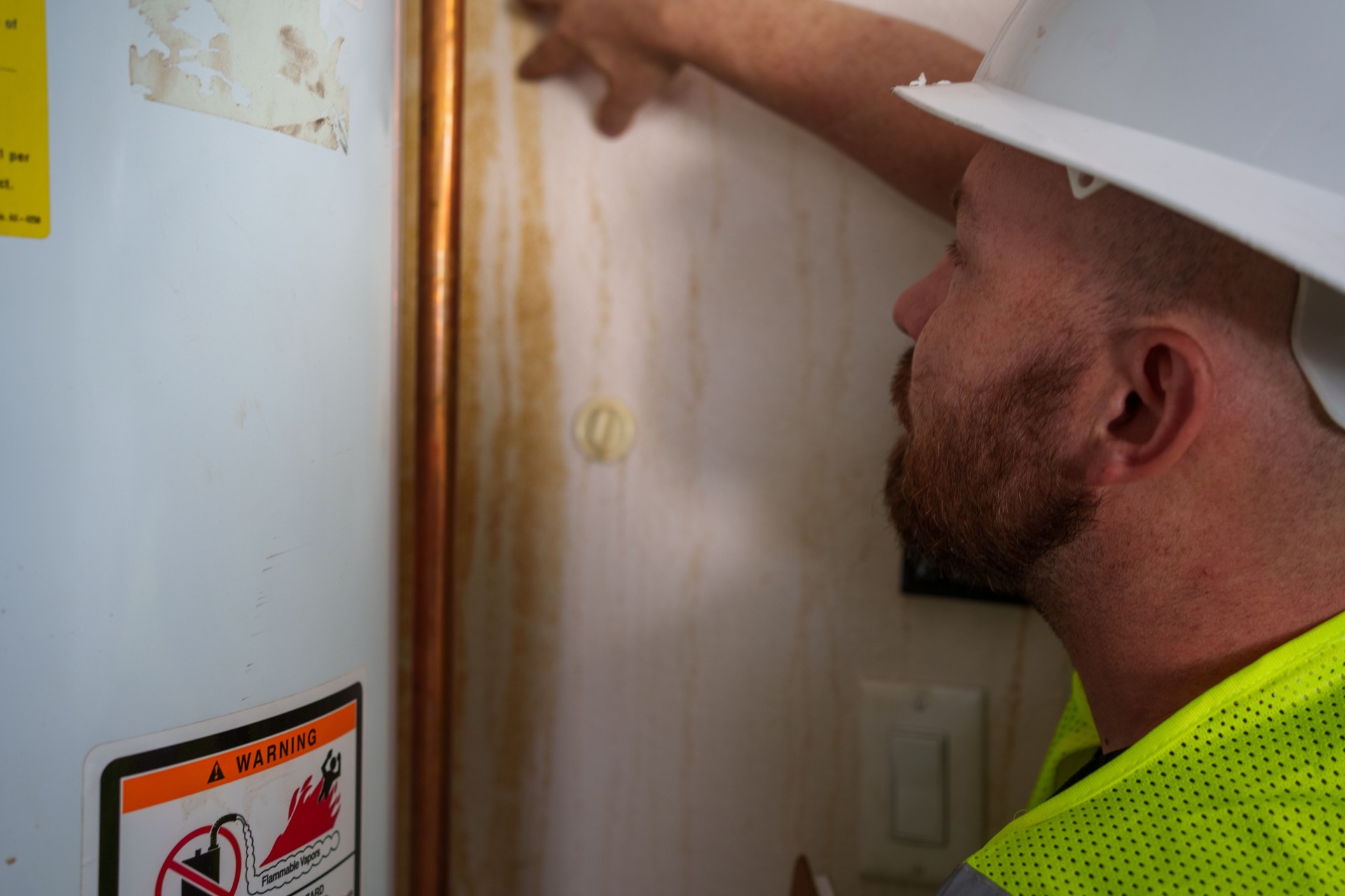 Young Caucasian Man in Hard Hat Performing Interior Home Inspection